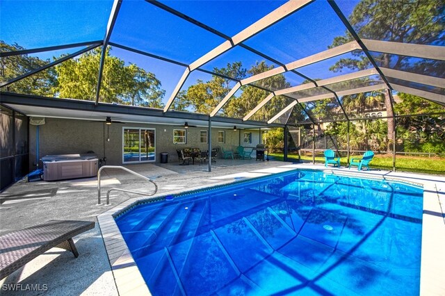 view of pool with a patio, a hot tub, ceiling fan, and a lanai