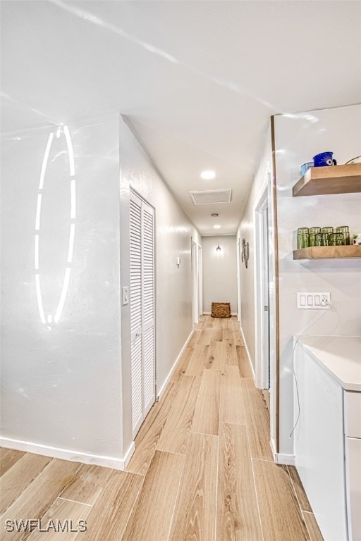 hall featuring light hardwood / wood-style flooring and washer / clothes dryer