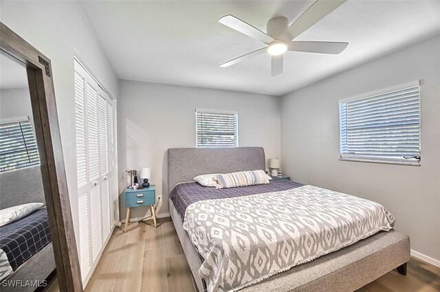 bedroom with a closet, light wood-type flooring, and ceiling fan