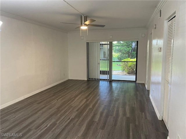 spare room featuring dark wood-style floors, baseboards, and ornamental molding