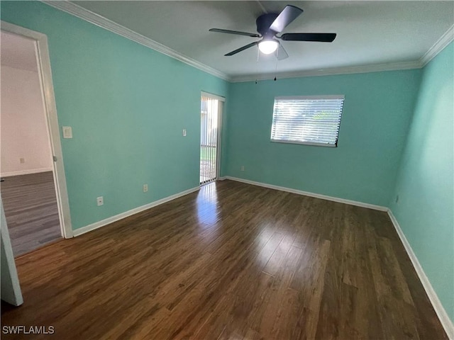 unfurnished room with dark wood-style floors, ornamental molding, and baseboards