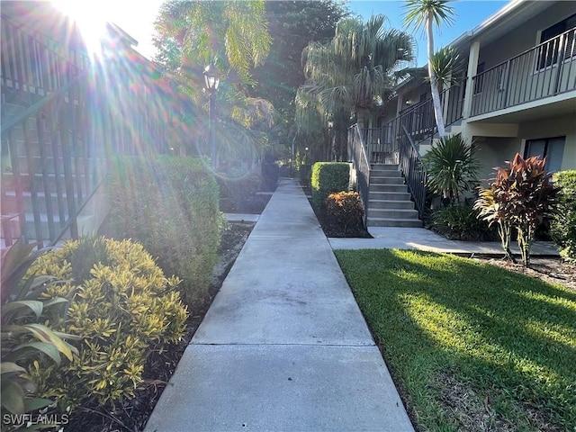 view of community with stairs and a yard