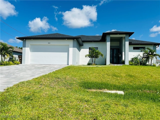 prairie-style home featuring a garage and a front yard