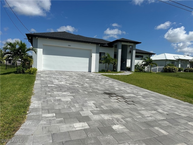 view of front of house featuring a front yard and a garage