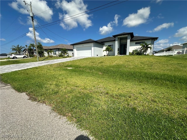 view of front facade featuring a garage and a front lawn