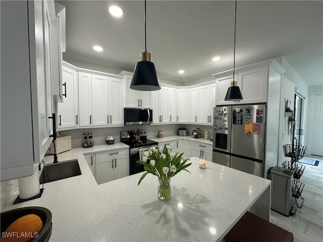 kitchen featuring white cabinets, stainless steel appliances, hanging light fixtures, and light stone countertops