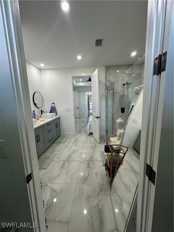 bathroom featuring vanity and a shower with door