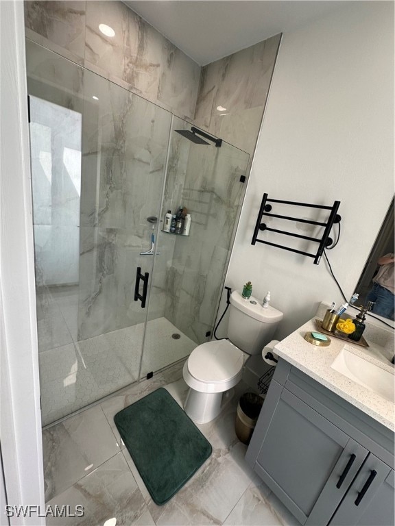 bathroom featuring vanity, toilet, and an enclosed shower