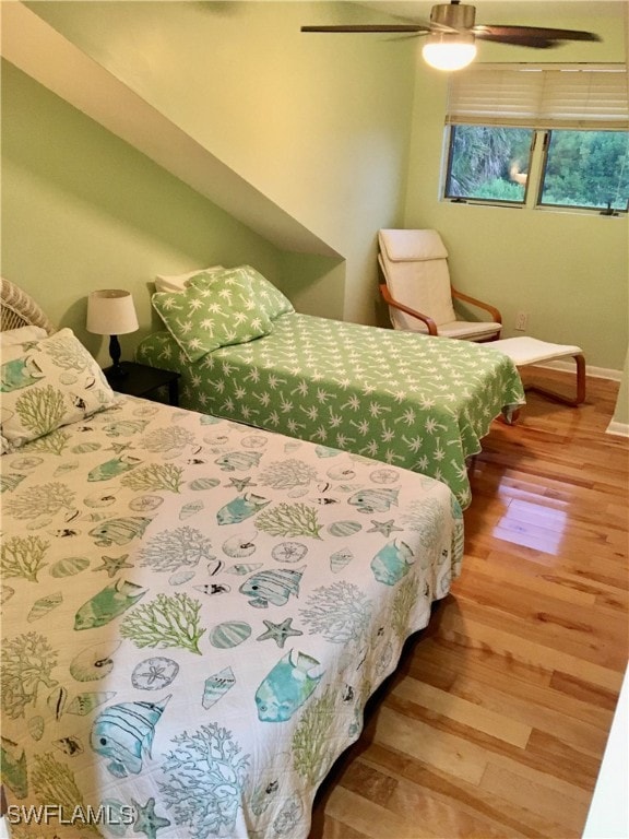 bedroom with ceiling fan and hardwood / wood-style flooring