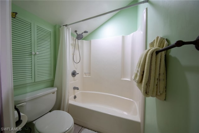 bathroom with shower / bath combo, lofted ceiling, toilet, and tile patterned floors