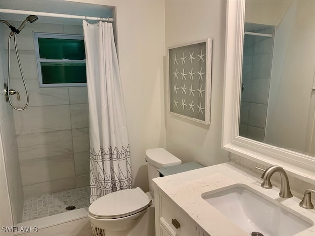 bathroom with vanity, tile patterned flooring, toilet, and curtained shower