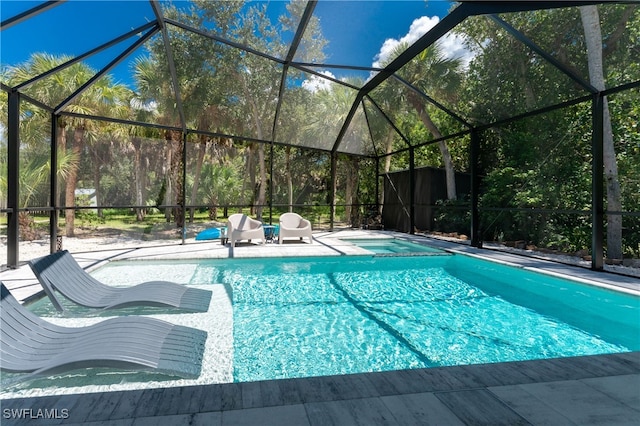 view of swimming pool with a lanai and a patio area