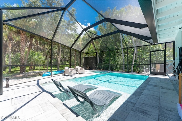 view of pool with a lanai and a patio