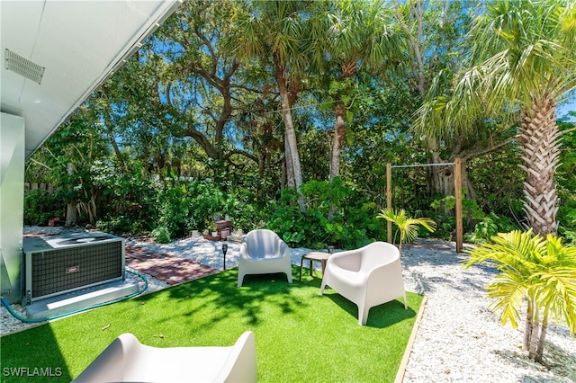 view of yard with a patio area and central air condition unit