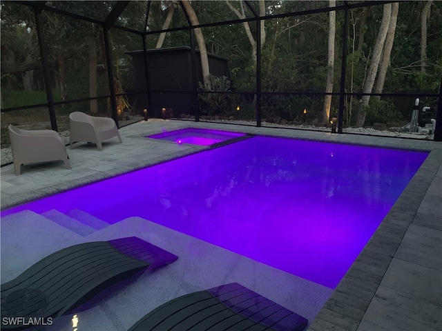 view of swimming pool featuring a lanai and a patio area