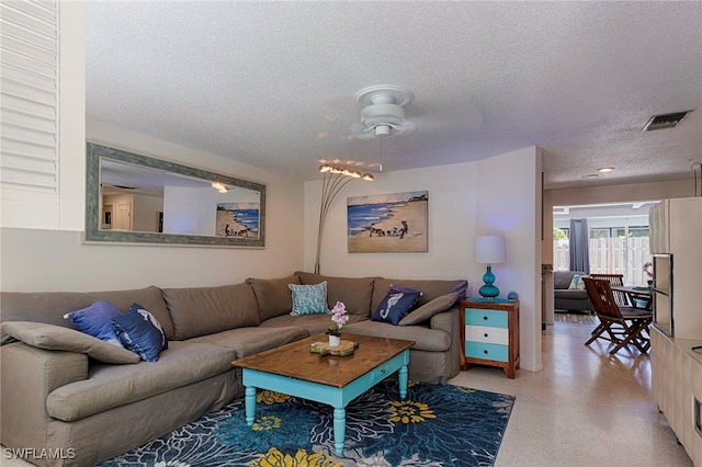 living room featuring a textured ceiling and ceiling fan