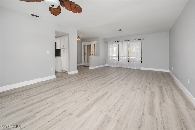 unfurnished living room with ceiling fan and light hardwood / wood-style floors