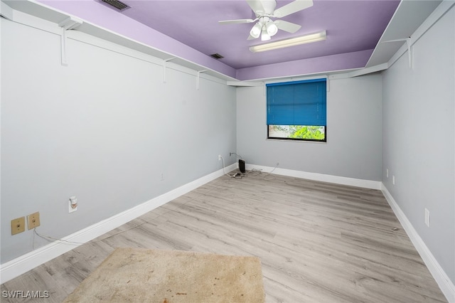 spare room with light hardwood / wood-style flooring and ceiling fan