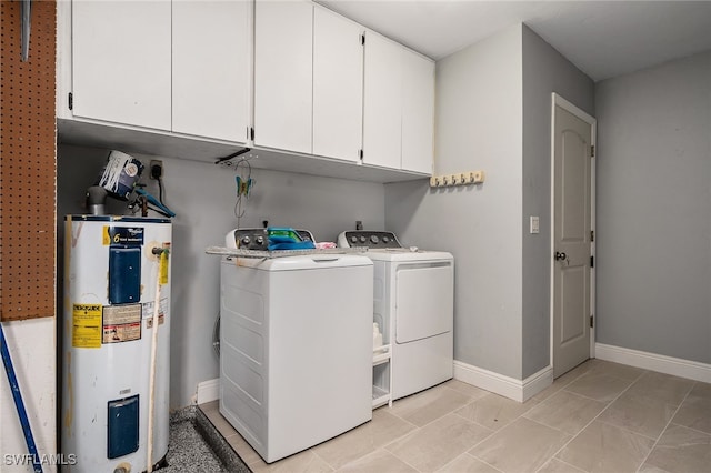 laundry area featuring cabinets, electric water heater, and separate washer and dryer