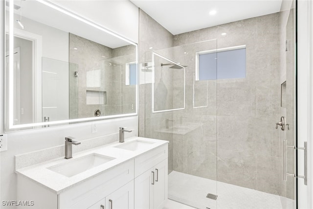 bathroom featuring vanity and a shower with door