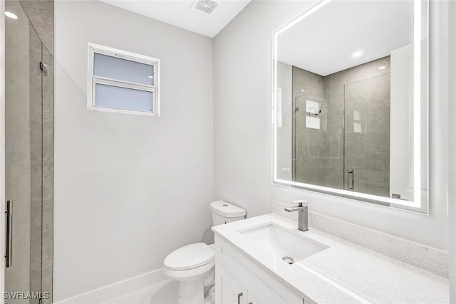 bathroom featuring walk in shower, vanity, and toilet