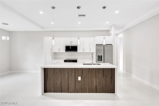 kitchen featuring white cabinets, stainless steel appliances, and hanging light fixtures