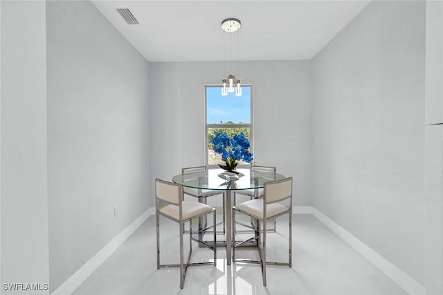 dining room with a chandelier, baseboards, and visible vents