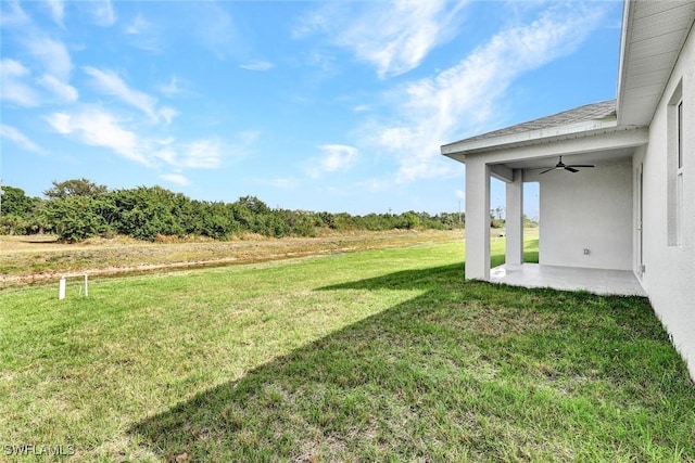 view of yard featuring ceiling fan and a patio area