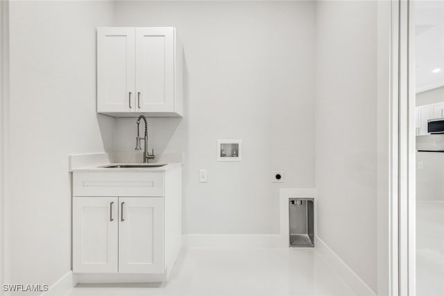 laundry area with cabinets, electric dryer hookup, hookup for a washing machine, and sink