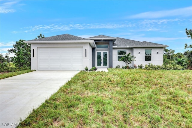 1155 Ermine St E, Lehigh Acres, FL 33974 - prairie-style home with french doors, stucco siding, a garage, concrete driveway, and a front yard