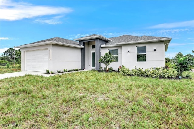 1155 Ermine St E, Lehigh Acres, FL 33974 - prairie-style house featuring an attached garage, stucco siding, concrete driveway, and roof with shingles