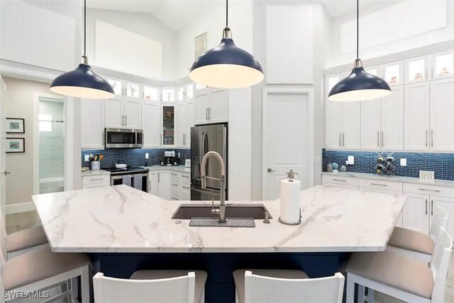 kitchen featuring a spacious island, stainless steel appliances, and hanging light fixtures