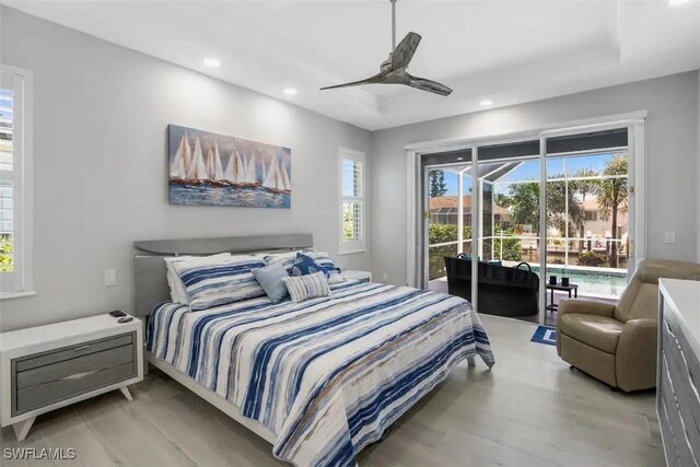 bedroom featuring access to outside, light hardwood / wood-style floors, and ceiling fan