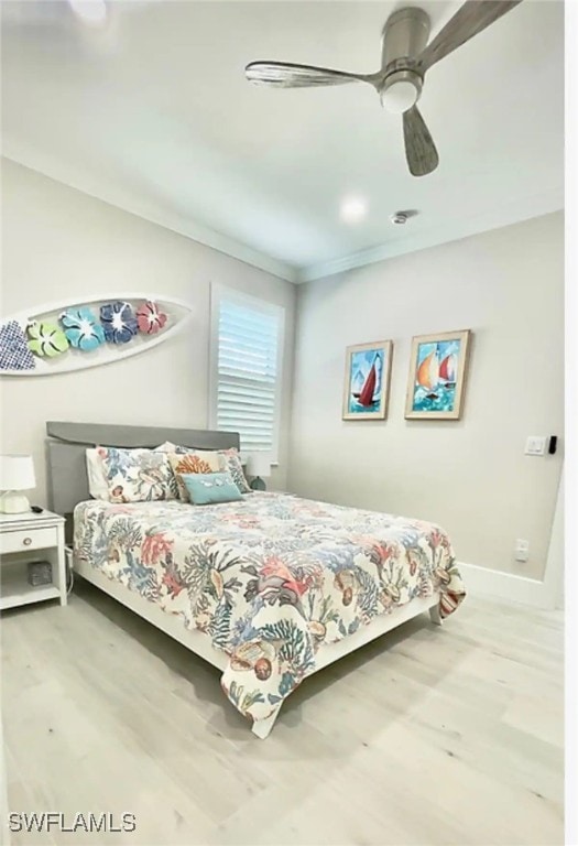 bedroom with wood-type flooring, ornamental molding, and ceiling fan