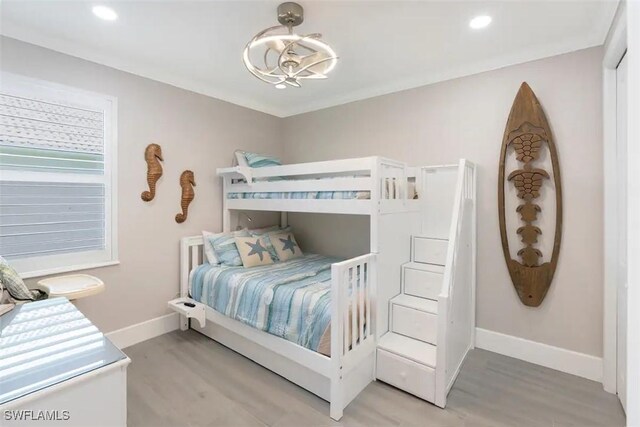 bedroom featuring light hardwood / wood-style flooring and a chandelier