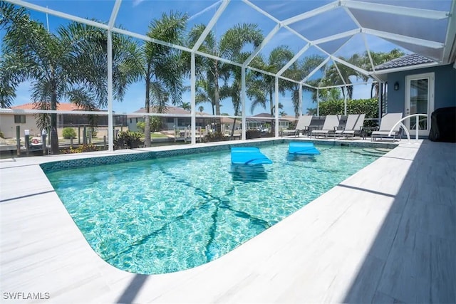 view of pool with a patio and a lanai