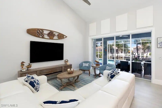 living room with high vaulted ceiling and hardwood / wood-style floors