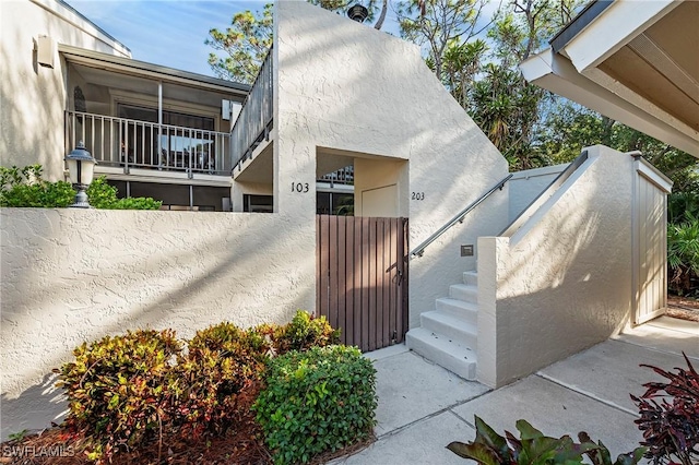 15330 Cedarwood Ln Unit 5-203, Naples, FL 34110 - view of exterior entry with stucco siding