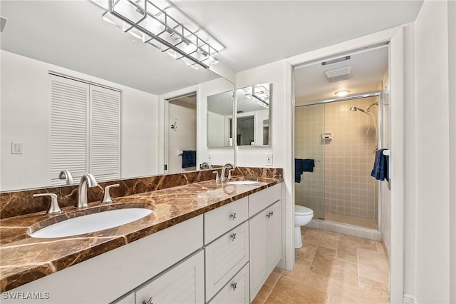 15330 Cedarwood Ln Unit 5-203, Naples, FL 34110 - full bathroom featuring toilet, double vanity, a shower stall, and stone finish flooring