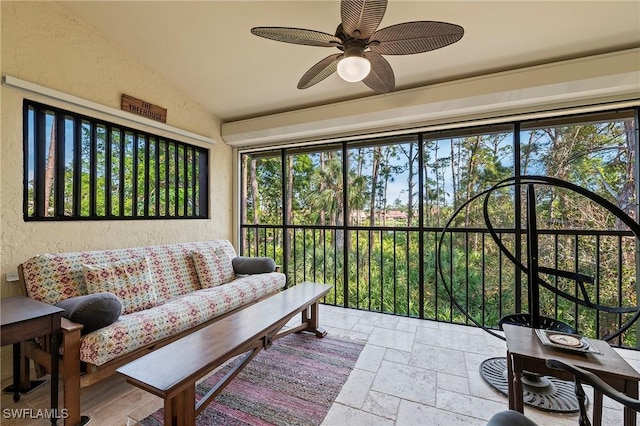 sunroom with lofted ceiling and ceiling fan