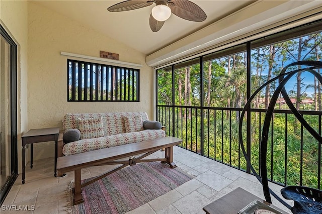 sunroom / solarium featuring lofted ceiling and ceiling fan