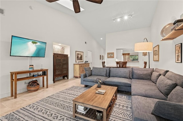 living room featuring ceiling fan and high vaulted ceiling