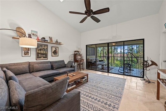 living room featuring ceiling fan and high vaulted ceiling