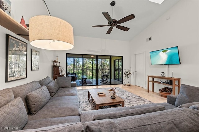 living room with ceiling fan and high vaulted ceiling