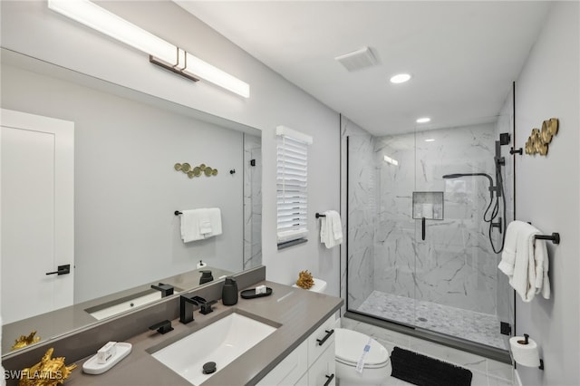 bathroom featuring a shower with door, vanity, and toilet