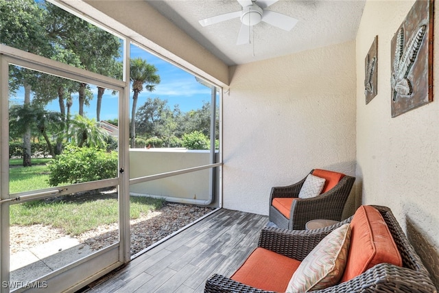 sunroom / solarium featuring ceiling fan