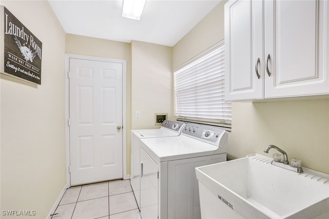 washroom featuring cabinets, light tile patterned floors, washer and dryer, and sink