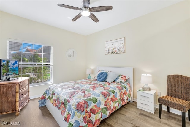 bedroom with light hardwood / wood-style floors and ceiling fan