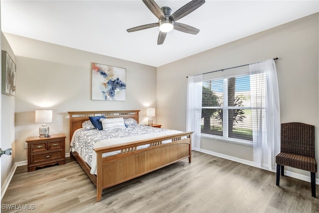 bedroom with hardwood / wood-style floors and ceiling fan