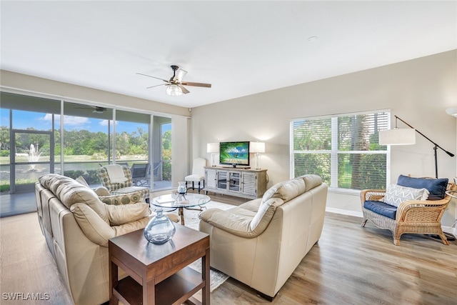 living room featuring light wood-type flooring and ceiling fan